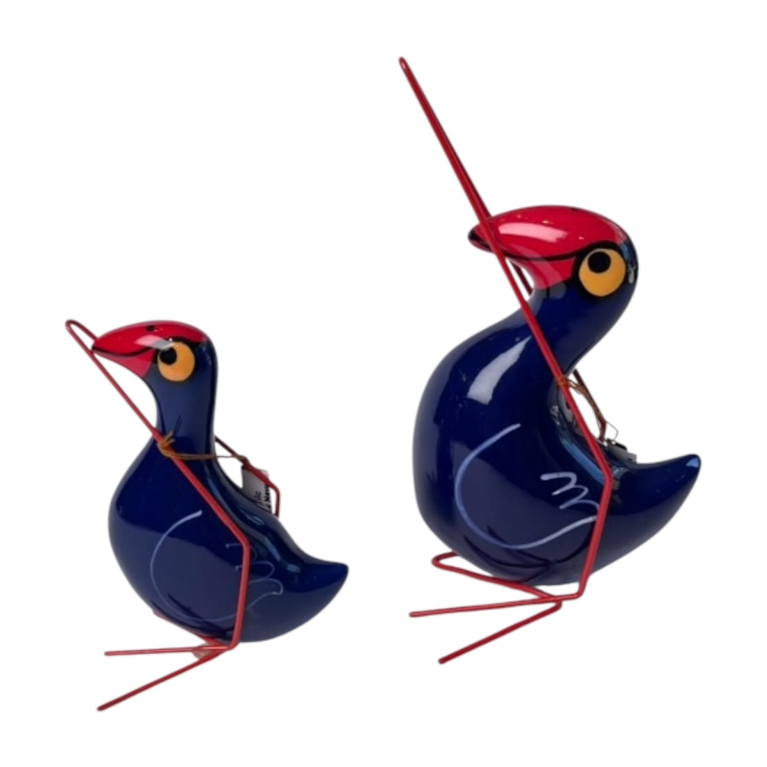 Pair of Hand Painted Ceramic Pukeko Bird Figure: Charming pair of hand-painted ceramic bird figures modeled after the distinctive p?keko, known for its deep blue plumage, dark body, red beak, and a stand mimicking their long legs. Each figure is ind