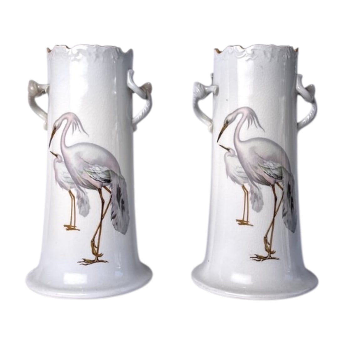 Pair of Hand-Painted Ceramic Crane Vases: A pair of tall ceramic vases featuring hand-painted crane and heron scenes in soft gray, lavender, green, and gold tones. Each vase has a white crackle-glaze finish, scalloped rim, flared base, and sc