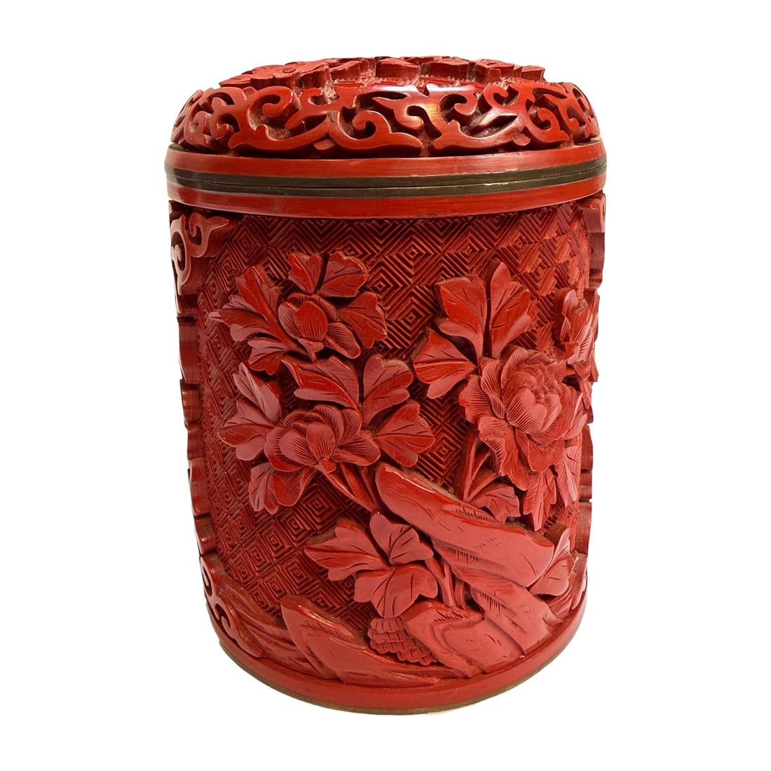 Antique Chinese Hand-Carved Cinnabar Canister Jar: A finely detailed antique Chinese cinnabar lacquer canister jar, featuring elaborate hand-carved floral decoration over a deeply incised geometric diaper ground. The jar is richly decorated with bloom