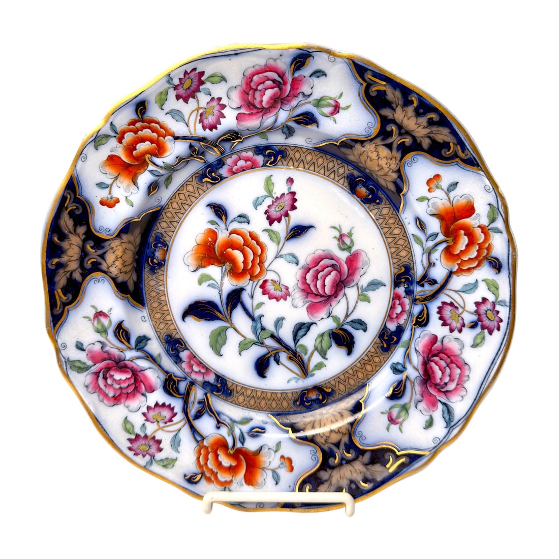 Vintage Eugenie Floral Porcelain Cabinet Plate with Cobalt Blue and Gilt Decoration: Decorative porcelain plate featuring a scalloped rim and an elaborate floral design in pink, orange, green, cobalt blue, and gold. The center and border are decorated with hand-finished floral sprays,