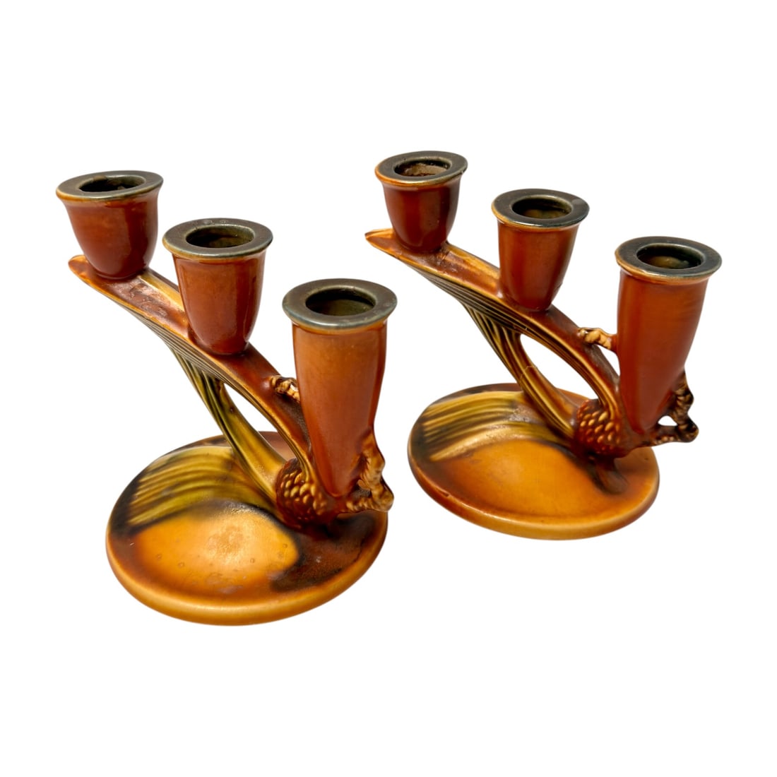 Pair of Vintage Roseville Pottery Triple Candleholders, Shape 1106-5: Pair of vintage Roseville Pottery ceramic triple candleholders featuring a streamlined branch-like form with three graduated candle cups on each piece. Finished in warm brown, amber, and olive-green g