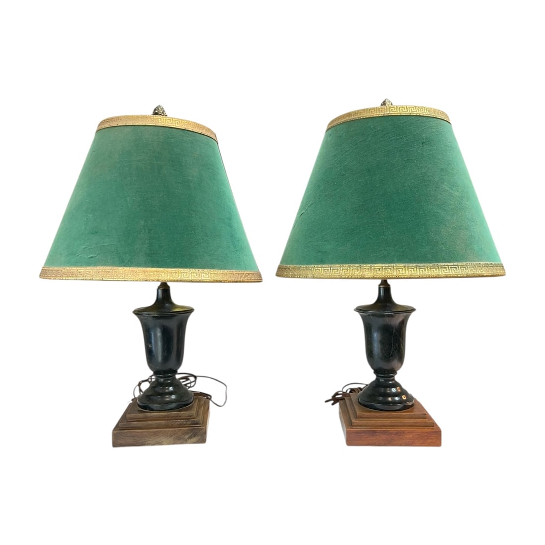 Pair Vintage Neoclassical Table Lamps Green Velvet Tole Shade Brass Urn Base: A matching pair of vintage table lamps showcasing a stately Neoclassical / Regency Revival aesthetic.Dating from the mid-to-late 20th century, each lamp is anchored by an elegant, dark patinated metal