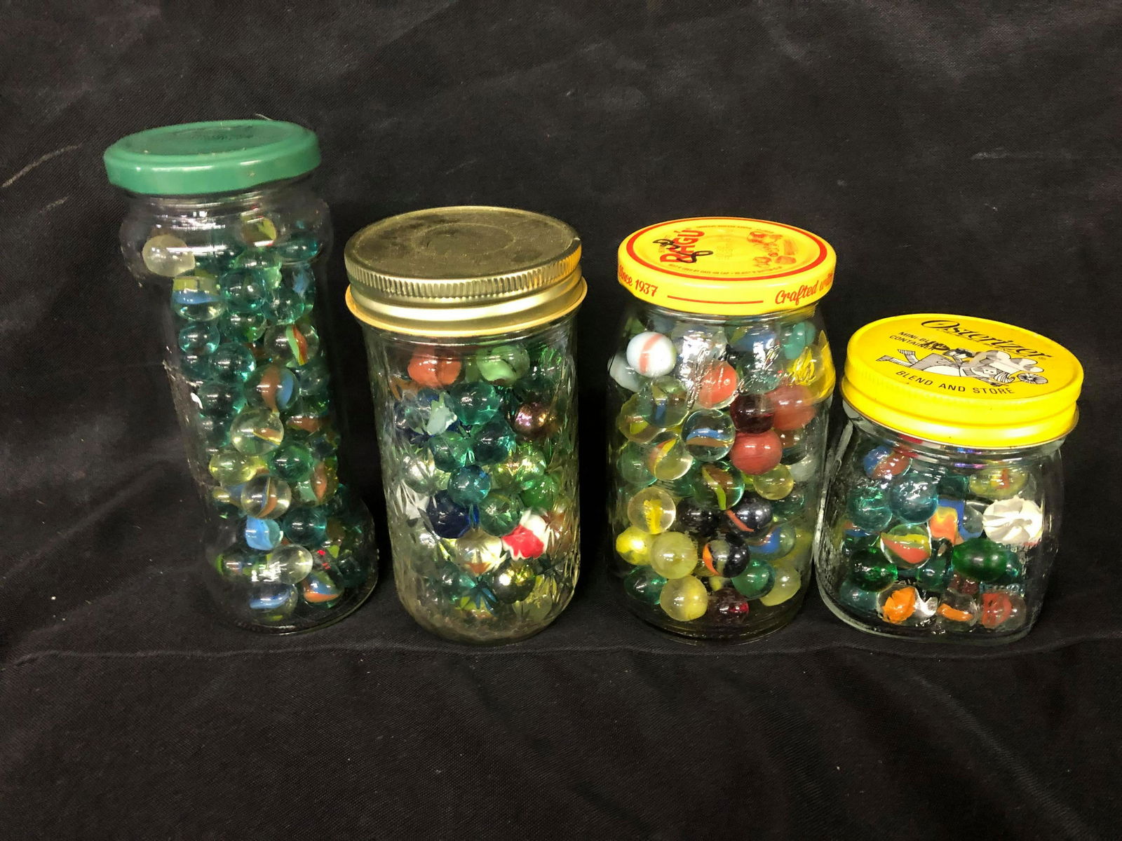 COLLECTION OF JARS OF MARBLES: COLLECTION OF JARS OF MARBLES