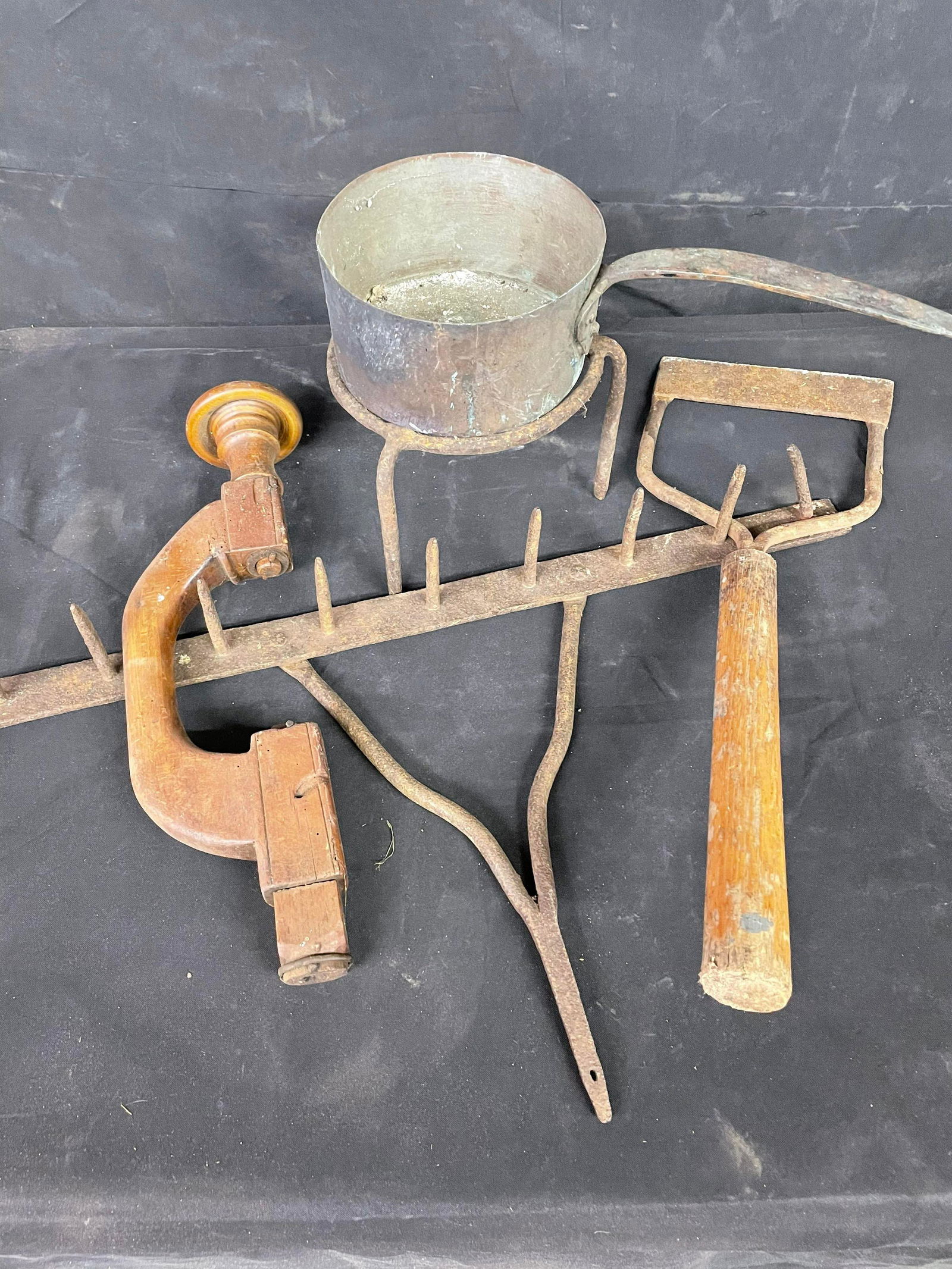 Array Of Primitive Items Including Rake Head And Kettle On Stand (1 of 1)