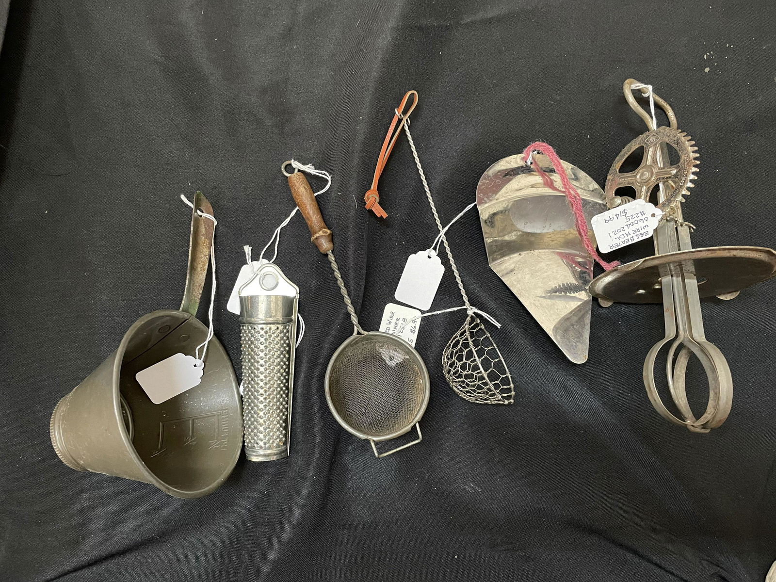 Collection Of Vintage Kitchen Items Including Egg Beater, Strainers, Graters And Tin Measuring Cup: Collection Of Vintage Kitchen Items Including Egg Beater, Strainers, Graters And Tin Measuring Cup