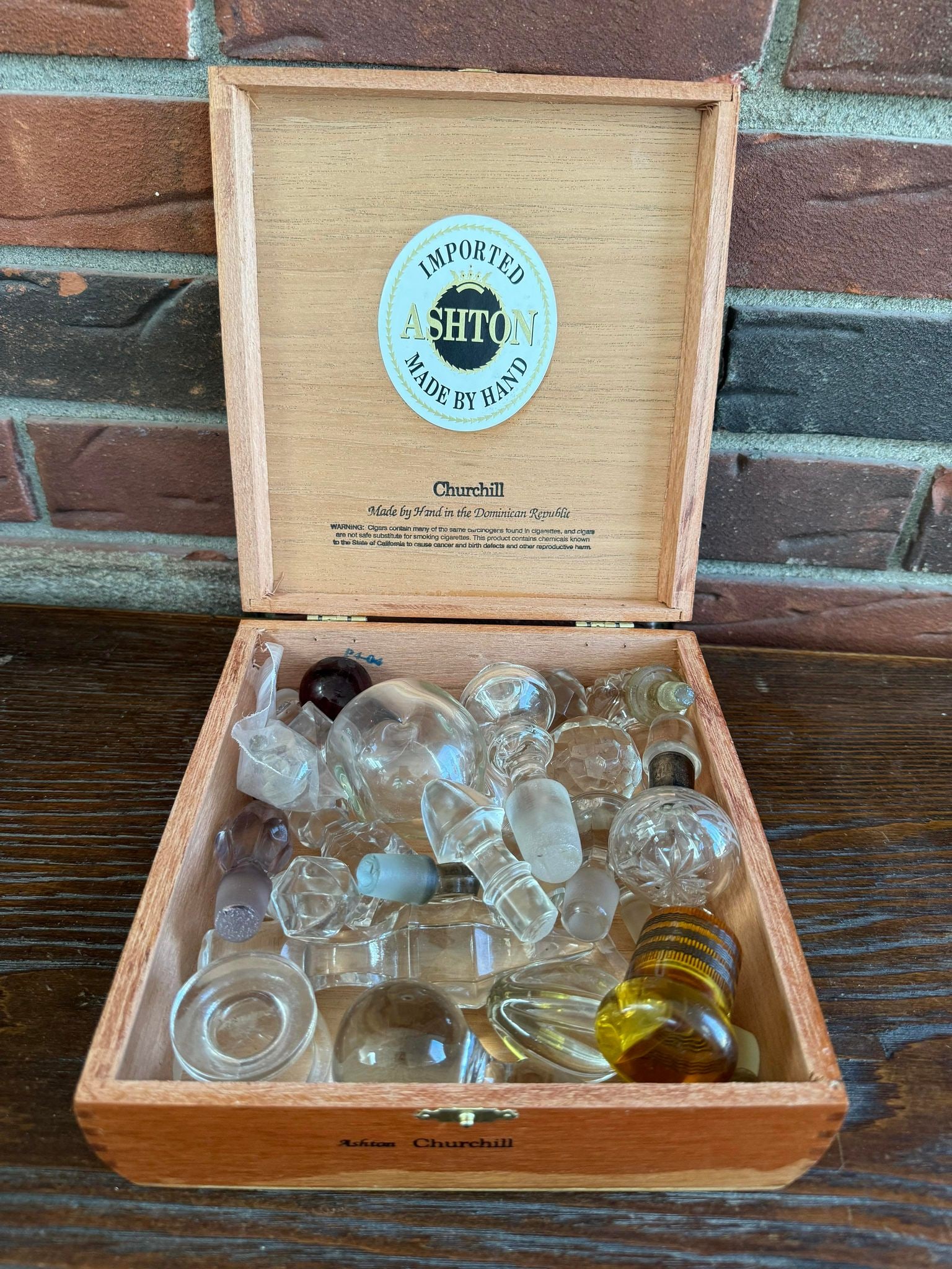 Collection of Decanter Stoppers in Cigar Box: Collection of Decanter Stoppers in Cigar Box