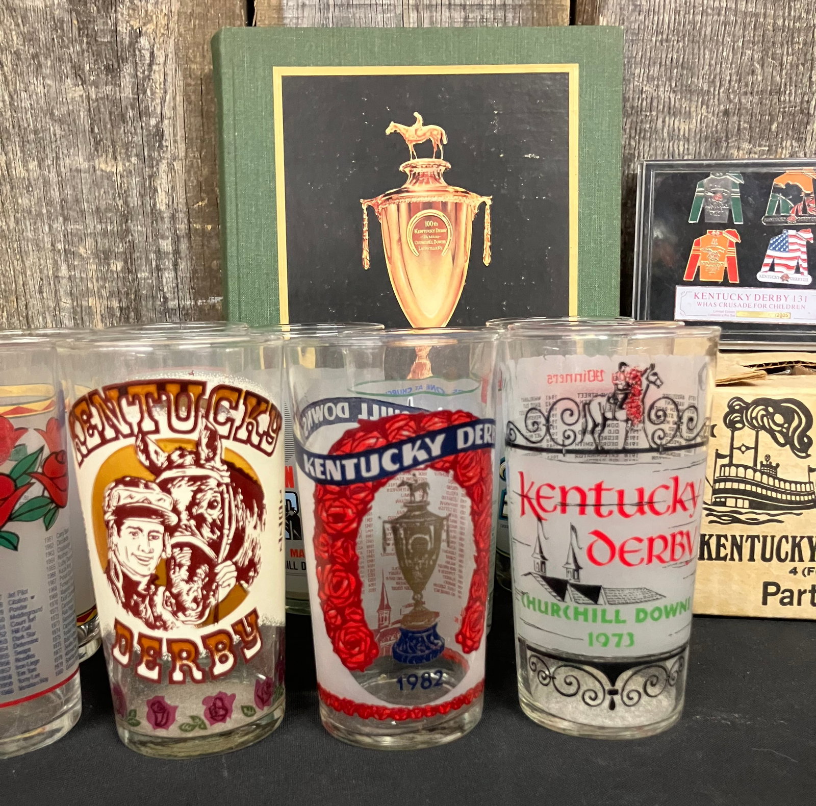 Kentucky Derby Lot Including 1973, 1977 And 1982 Mint Julep Glasses With Collectible Pins, Party: Kentucky Derby Lot Including 1973, 1977 And 1982 Mint Julep Glasses With Collectible Pins, Party Glasses And KY Derby Book