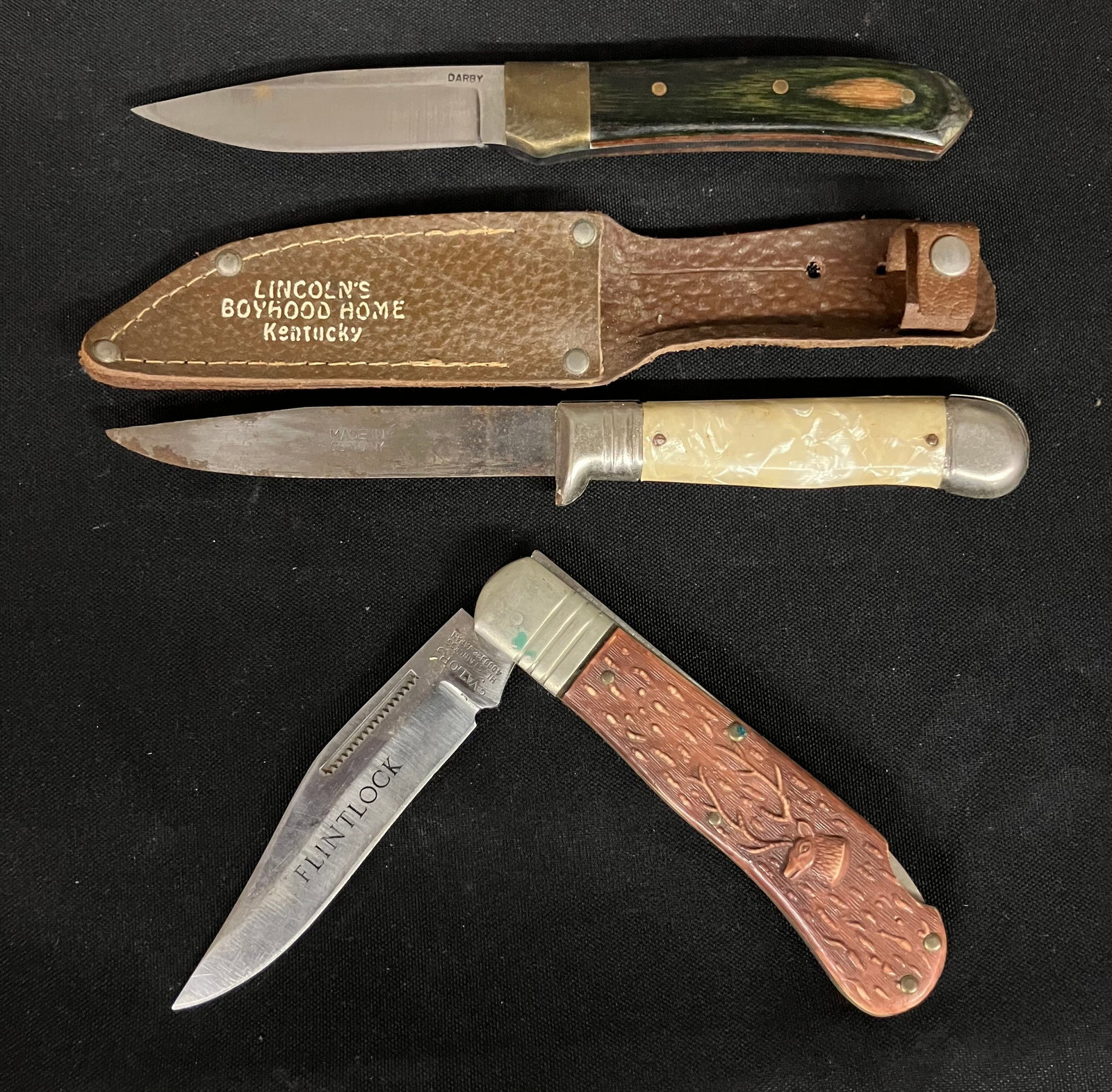 Trio Including "Darby" Knife, Pearl Handle "Made In Germany" Knife With "Lincoln's Boyhood Home": Trio Including "Darby" Knife, Pearl Handle "Made In Germany" Knife With "Lincoln's Boyhood Home" Sheath (8") And "Flintlock" Knife By Valor (Japan) With Stag Design Handle