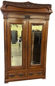 Walnut Victorian Wardrobe Or Armoire With Carved Crest And Mirrored Doors Over A Two Drawer Base