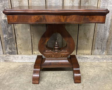 Antique American Empire Flame Mahogany Game Table featuring a Serpentine Top and Lyre-shaped Support: Antique American Empire Flame Mahogany Game Table featuring a Serpentine Top and Lyre-shaped Support Resting on a Scrolled Base 17"X33"X29"