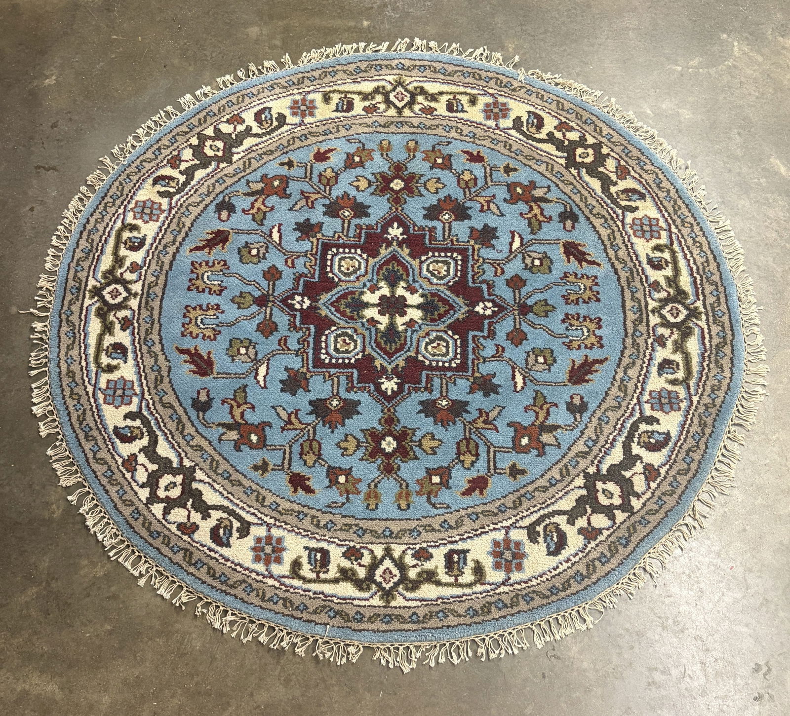 Round, Hand-knotted Tribal Indo Heriz Wool Rug featuring a Central Medallion and Geometric Botanical: Round, Hand-knotted Tribal Indo Heriz Wool Rug featuring a Central Medallion and Geometric Botanical Motifs on a Light Blue Background - 63"