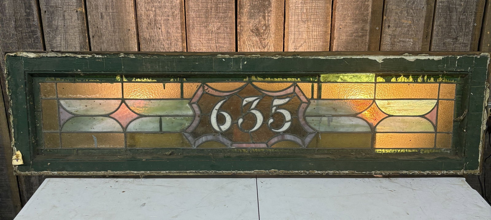 An Original, Salvaged, likely late 19th or early 20th century, American Victorian or Craftsman Style: An Original, Salvaged, likely late 19th or early 20th century, American Victorian or Craftsman Style Stained Leaded Glass Transom Window Number 635 - 52.5"x14"