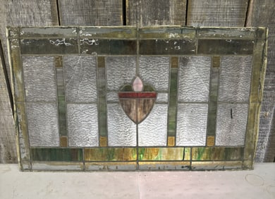 Antique Stained Glass Window Pane featuring a Central Shield Motif - 32"x19"