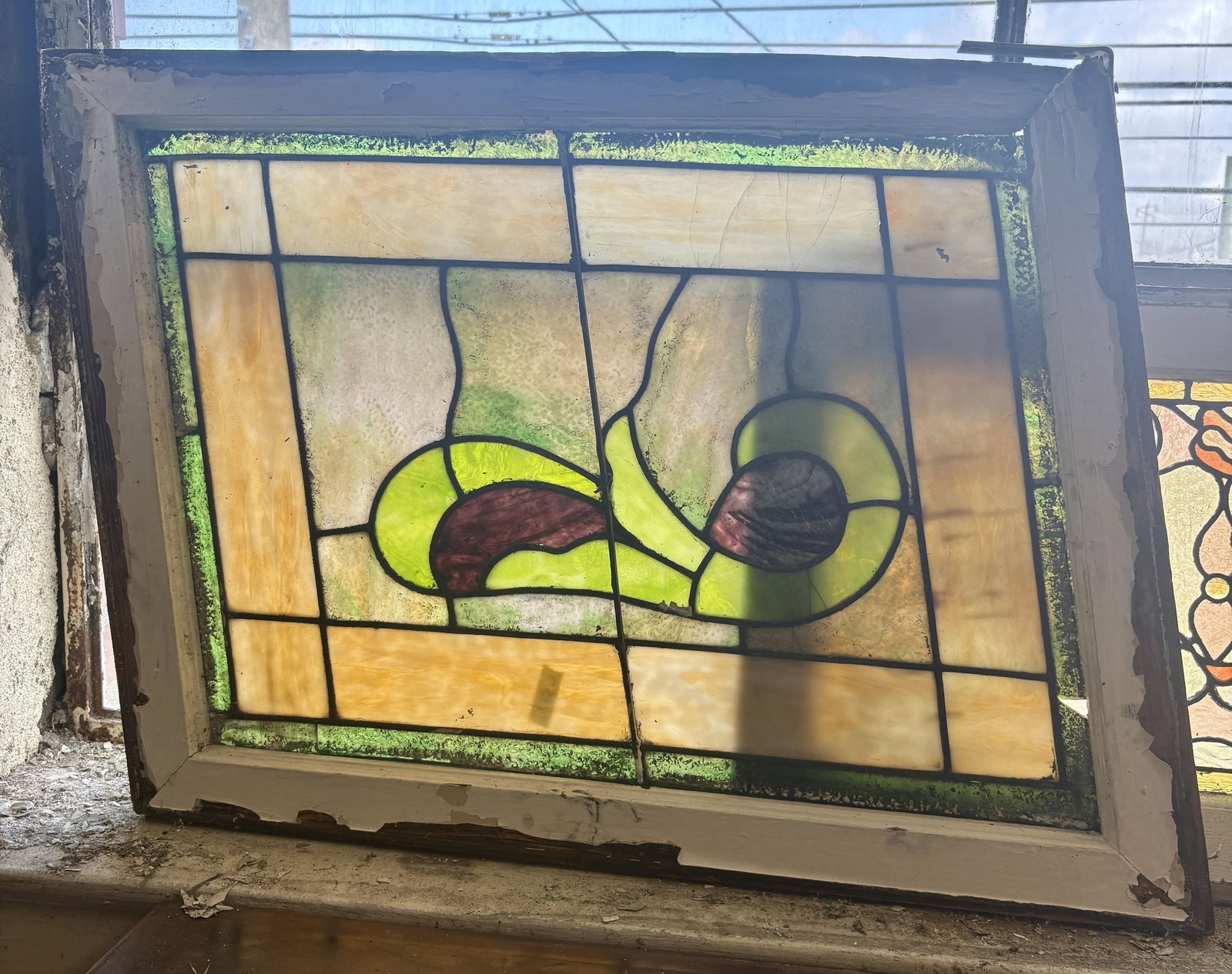 Antique Stained Glass Window Panel featuring a Central Motif with Curved Green and Purple Glass: Antique Stained Glass Window Panel featuring a Central Motif with Curved Green and Purple Glass Pieces on Textured Amber Color Background Glass - 32"x24"x