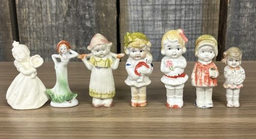 This Lot Features a Collection of Vintage Bisque Porcelain Figures, Commonly Known as "Frozen: This Lot Features a Collection of Vintage Bisque Porcelain Figures, Commonly Known as "Frozen Charlotte" or "Penny dolls," manufactured in Japan during the early-to-mid 20th century - 2"x3"