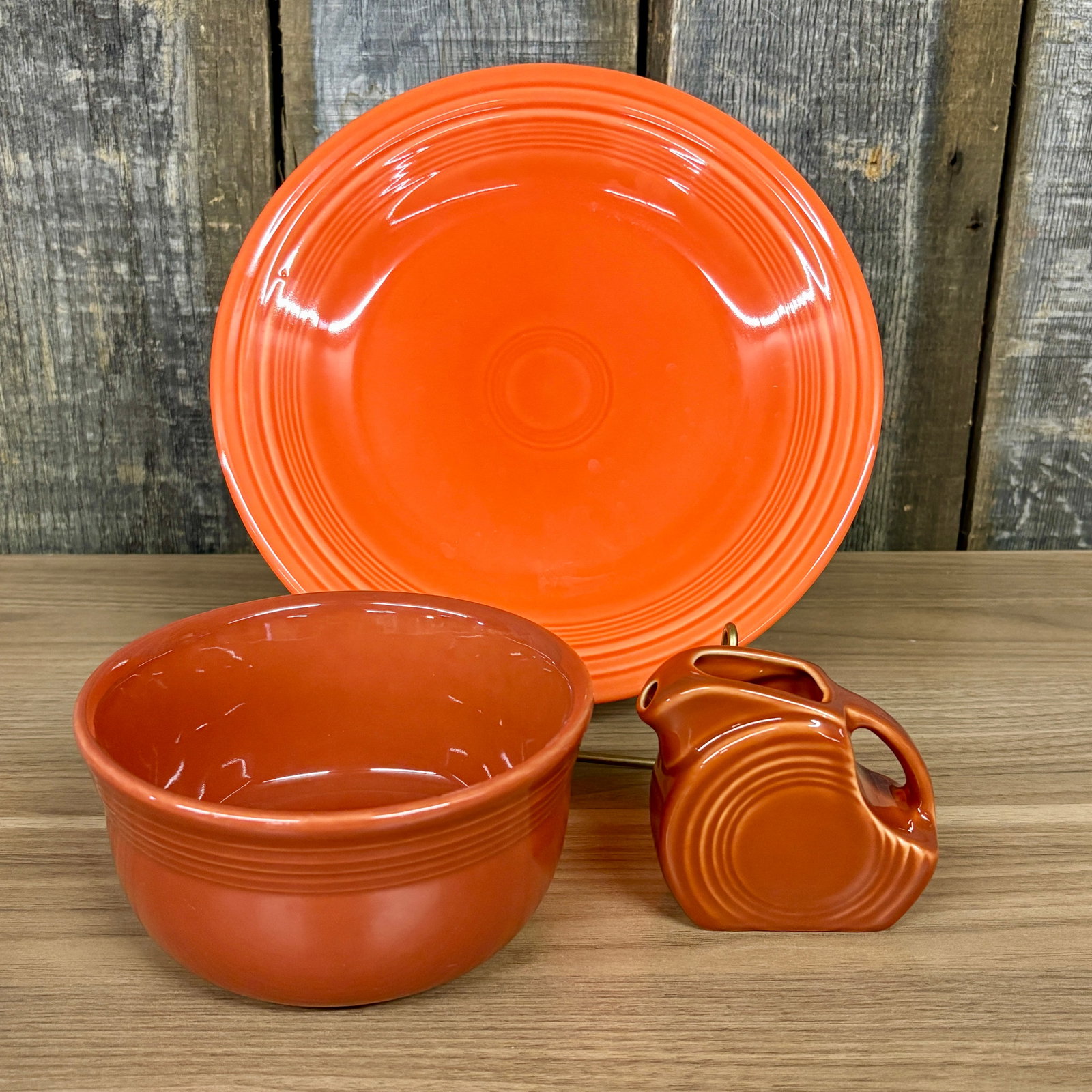 Three Pieces of Fiesta Dinnerware in Two Distinct Shades of Orange: a bright red-orange and a (1 of 5)