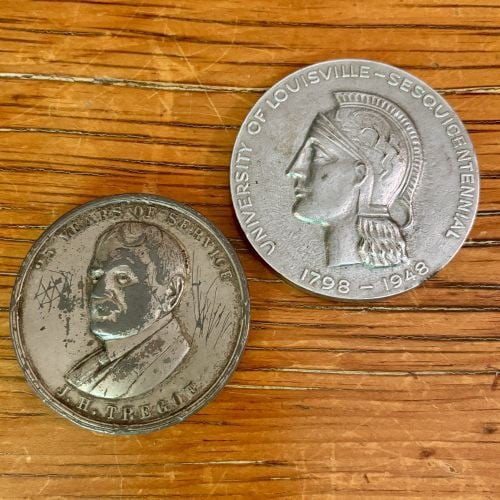 Two US Commemorative Medals, Louisville, Kentucky - 3": A group of two US commemorative medals associated with Louisville, KY. The first is a white-metal medal issued in June 1922 to honor J.H. Tregoe. The obverse features a profile portrait with the inscr