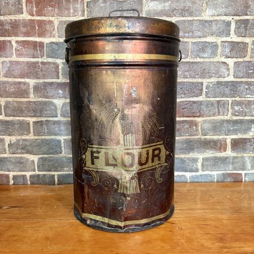 Antique Lithographed Tin Flour Bin with Bronzed Finish 13"X13"X23": This large antique cylindrical flour storage bin is constructed from lithographed tin and dates to the late 19th or early 20th century. The exterior features a bronzed or copper-toned metallic finish 