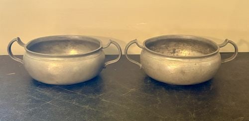 A Pair of Continental European Pewter Two-Handled Bowls with Rose and Crown Marks 6"X8"X3": A pair of cast pewter two-handled bowls, likely used as porringers or small soup vessels. Each bowl features a bulbous, rounded body with a short, slightly flared rim and is flanked by two applied cas