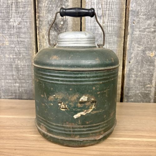 Vintage Insulated Thermal Picnic Jug with Ceramic Liner: This is a vintage insulated thermal picnic jug, a classic travel accessory used for motoring and camping during the early to mid-20th century. The object consists of a green-painted metal exterior she