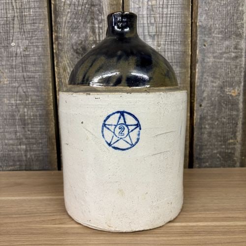 Star Stoneware Company 2-Gallon Two-Tone Stoneware Jug: This is a 2-gallon stoneware jug produced by the Star Stoneware Company of Crooksville, Ohio. The vessel features a cylindrical form with a rounded shoulder and a single loop handle attached at the ne