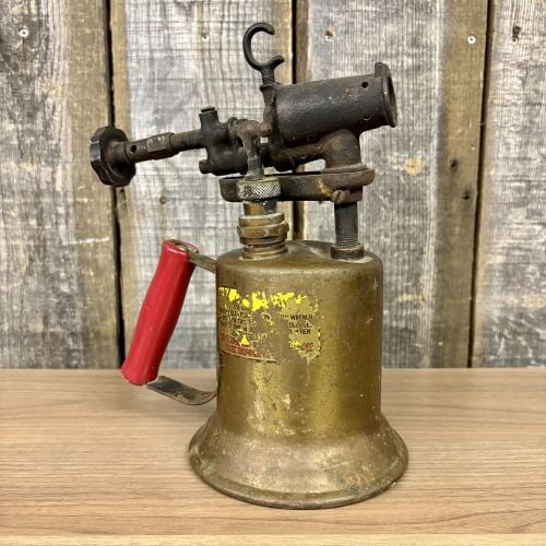Vintage Clayton and Lambert Protection Brass Gasoline Blowtorch: A vintage gasoline blowtorch manufactured by the Clayton and Lambert Manufacturing Co. of Louisville, Kentucky. This industrial tool features a cylindrical brass fuel tank with a flared base and a cas