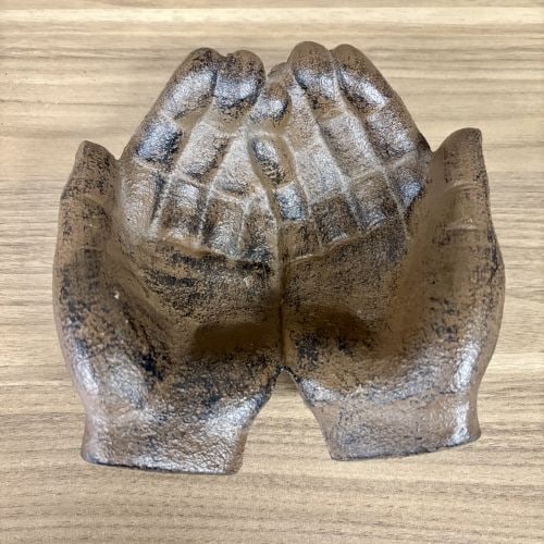 Cast Iron Cupped Hands Decorative Dish in Rust Finish: Attributed to the Hello Honey or Storied Home collections, this contemporary decorative dish is constructed from sand-cast iron in the form of two cupped, open hands. The piece features a textured, gr