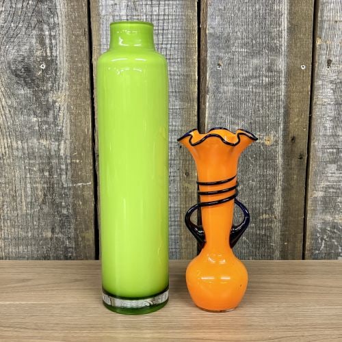 Two Mid-Century Modern Style Art Glass Vases Including a Czechoslovakian Tango Style Vase: This lot contains two vibrant art glass vases of varying forms and styles. The first is a tall, cased glass cylinder vase, featuring a bright lime green interior encased in a clear glass outer layer. 