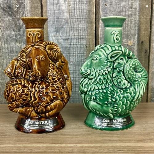 A Pair of Frankfort Distilling Co. Rare Antique Zodiac Series Ceramic Whiskey Decanters: This lot comprises two relief-molded glazed ceramic whiskey decanters from the Rare Antique zodiac series produced for the Frankfort Distilling Co. of Louisville, Kentucky, circa 1970. Each decanter f