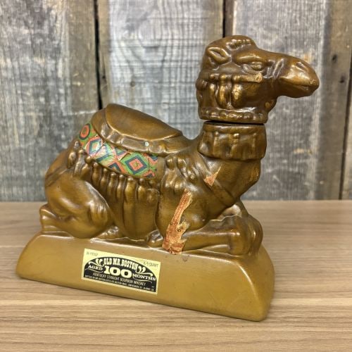 Old Mr. Boston A.A.O.N.M.S. Shrine U.S. Bicentennial Figural Camel Whiskey Decanter: This figural whiskey decanter was produced for Old Mr. Boston to commemorate the United States Bicentennial and the A.A.O.N.M.S. Shrine organization. The item is modeled in the form of a seated camel 