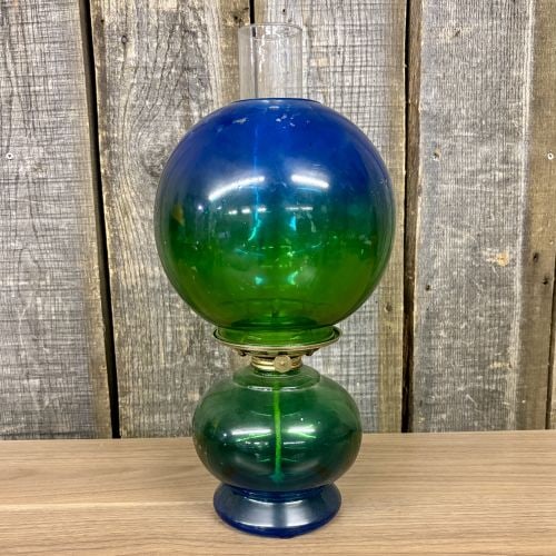 Vintage Risdon Blue and Green Gone with the Wind Style Glass Oil Lamp: A Victorian-style oil lamp manufactured by the Risdon Manufacturing Co. of Danbury, Connecticut. The lamp features cased glass with a two-tone ombré color gradient transitioning from deep cobalt blue
