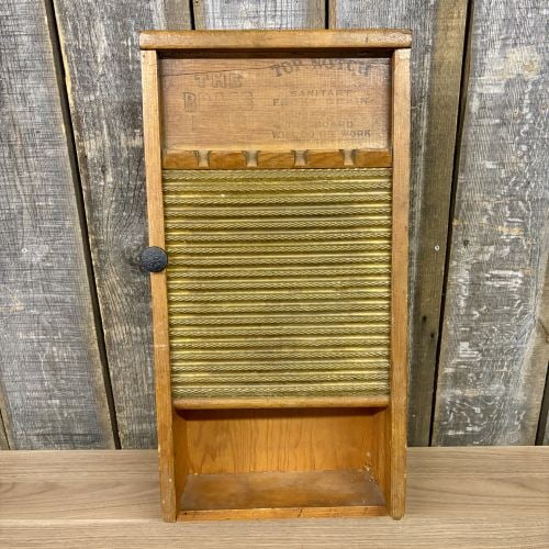 Repurposed National Washboard Co No 801 The Brass King Wood and Brass Wall Cabinet: This wall-mounted storage cabinet is a decorative piece repurposed from a vintage National Washboard Company washboard. The unit utilizes the original washboard frame as a hinged door, which is attach