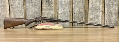 Belgian-Made Side-by-Side Hammer Shotgun 16 Gauge with 32 Inch Barrel Antique: A Belgian-manufactured side-by-side break-action shotgun chambered in 16 gauge. The firearm features 32-inch barrels with a textured top rib and a bead front sight. It is configured with external hamm