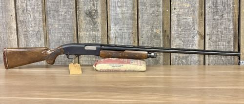 Winchester Model 1200 Pump-Action Shotgun 12 Gauge: This Winchester Model 1200 is a pump-action shotgun chambered for 12 gauge shells. It is equipped with a blued steel barrel featuring a full-length ventilated rib. The receiver has a matte black finis
