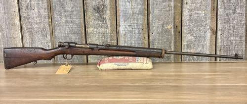 Japanese Type 38 Arisaka Bolt Action Rifle 6.5x50mm with 31.4 Inch Barrel: A Japanese Type 38 Arisaka bolt action rifle chambered in 6.5x50mm, featuring a standard 31.4 inch barrel. The rifle measures approximately 50 3/8 inches in overall length as indicated by the included