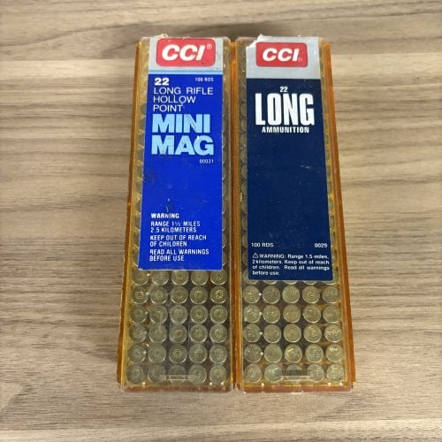 CCI Mini-Mag and 22 Long Rimfire Ammunition .22 Caliber: This lot consists of a pair of CCI brand 100-round boxes of .22 caliber rimfire ammunition (One Box Partial) presented in signature amber-colored plastic dispenser packaging. The first container is la