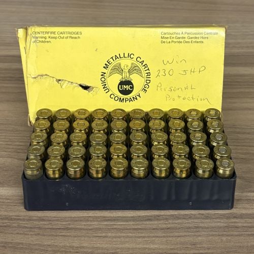 A Lot of 50 .45 Auto Centerfire Cartridges in a Union Metallic Cartridge Company Box: This lot consists of 50 rounds of .45 Auto centerfire ammunition contained within a yellow cardboard box from the Union Metallic Cartridge Company. The cartridges are organized in a 5x10 grid within a