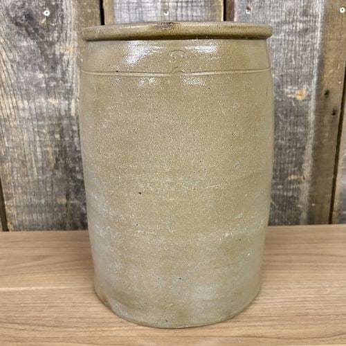 American Two Gallon Salt Glazed Stoneware Storage Crock: This is a cylindrical American salt-glazed stoneware storage crock or jar, likely dating to the late 19th century. The vessel features a two-gallon capacity and is designed with a slightly flared, rou