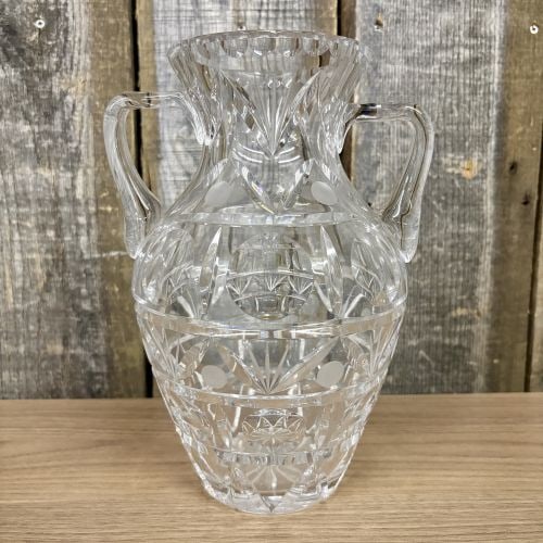 Two-Handled Cut Crystal Trophy Vase Attributed to Crystal Clear Industries Astor Pattern: A large, clear cut crystal trophy vase featuring an amphora-style form with two applied C-scroll handles. The body is decorated with a complex wheel-cut geometric pattern arranged in horizontal tiers.