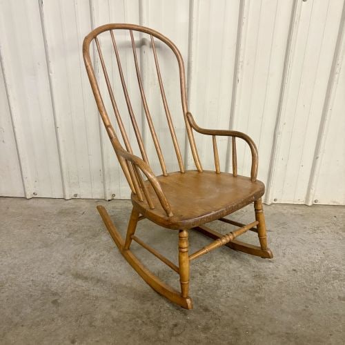 American Windsor Style Hoop Back Rocking Chair: One American Windsor style hoop back rocking chair constructed from a combination of hardwoods. The design features a bentwood hoop back containing seven vertical spindles. The bentwood armrests are s