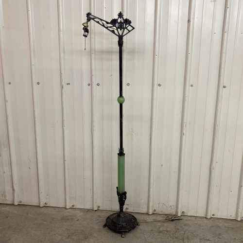 Art Deco Cast Metal Bridge Arm Floor Lamp with Uranium Glass Accents: This Art Deco style bridge arm floor lamp is constructed of cast metal with a dark, aged finish. The design features decorative translucent green glass components, including a spherical break on the u
