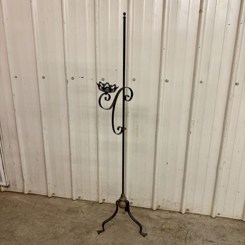 Vintage Wrought Iron Adjustable Floor Standing Candle Holder with Brass Accents: A floor-standing candle holder constructed from wrought iron with a black finish and decorative brass elements. The piece features a slender central shaft topped with a brass ball finial. It is suppor