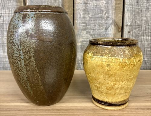 Two American Studio Pottery Stoneware Jars, one Signed Truong 1992: This lot features two distinct hand-crafted studio pottery jars produced in the late 20th century. The larger vessel is an ovoid stoneware jar with a narrow mouth and a thickened, rounded rim. It is f