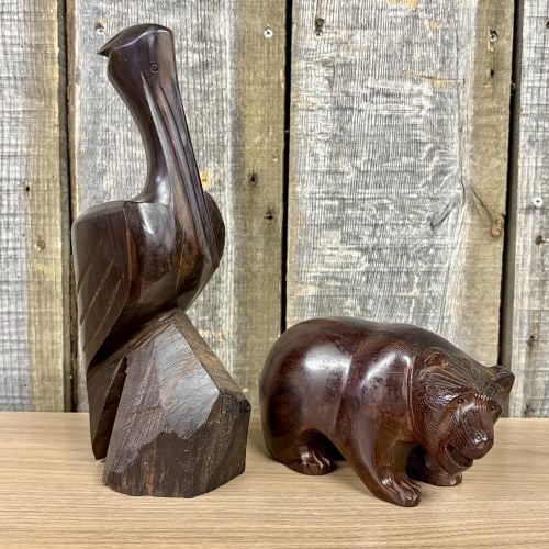 Two Hand-Carved Desert Ironwood Animal Figures, Pelican and Bear: This lot features two hand-carved hardwood animal figurines, consisting of a pelican and a bear. Both pieces are crafted from dense, dark-grained desert ironwood (Olneya tesota), a material characteri