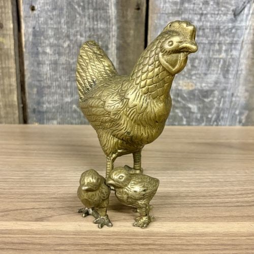 A Trio of Mid-20th Century Brass Chicken Figurines: This set of three decorative figurines features a standing hen and two separate chicks. Each piece is cast in solid brass and displays textural detailing to represent feathers, combs, and eyes. The he