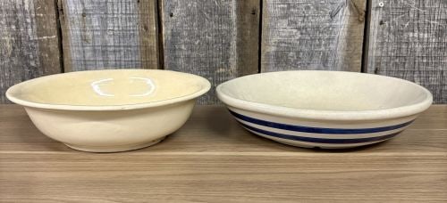 A Pair of Vintage American Ceramic Bowls by McCoy and Robinson-Ransbottom: This lot consists of two vintage American ceramic bowls produced by well-known Ohio manufacturers. The first is a deep, round stoneware bowl manufactured by McCoy Pottery, finished in a solid yellow g