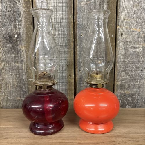 A Pair of Vintage Glass Oil Lamps with Plume & Atwood Eagle Burners: This pair of vintage kerosene or oil lamps features decorative glass fonts and brass-tone metal burners. Both lamps are equipped with burners manufactured by the Plume & Atwood Manufacturing Company, 