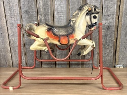 Vintage Wonder Horse Spring Action Rocking Horse: A mid-century spring-action rocking horse manufactured by Wonder Horse. The toy consists of a blow-molded hard plastic horse body suspended by a four-spring mechanism within a red-painted tubular meta