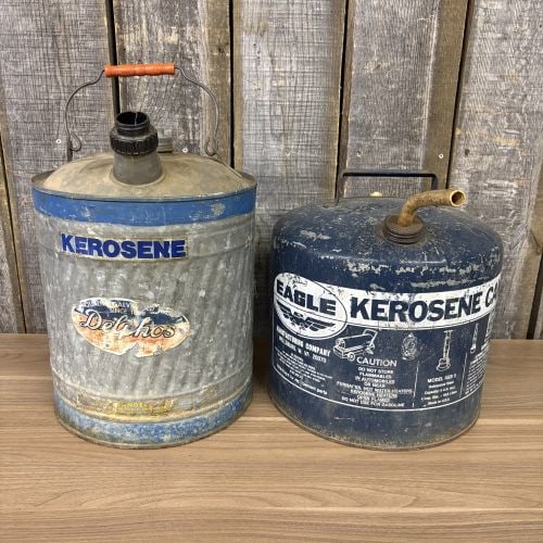 Two Vintage Kerosene Cans, Delphos and Eagle 5 Gallon Models: This lot features two vintage metal kerosene fuel cans of United States origin. The first is a Delphos brand can constructed of galvanized steel with blue painted bands at the top and base. It feature