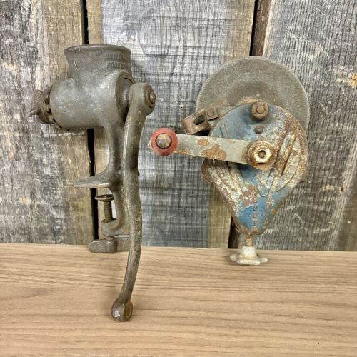 Two Vintage Hand-Crank Tools Including a Universal Food Chopper and a Wardway Bench Grinder: This lot features two manual American-made utility tools from the early-to-mid 20th century. The first item is a cast iron food grinder manufactured by Landers, Frary & Clark of New Britain, Connectic